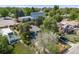 An aerial view showcases a charming home with a well-kept yard and mature trees in a vibrant neighborhood at 1765 Xenia St, Denver, CO 80220
