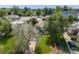 An aerial view of the home showing the manicured lawn, mature trees, landscaping, and the surrounding neighborhood at 1765 Xenia St, Denver, CO 80220