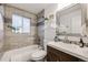 Bathroom with a shower-tub combination, decorative tile, and a modern vanity at 1765 Xenia St, Denver, CO 80220