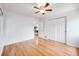 Bedroom with hardwood floors, neutral paint, and a double closet at 1765 Xenia St, Denver, CO 80220