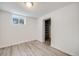 Bright bedroom with neutral walls, plank flooring, window, and closet with adjustable shelves at 1765 Xenia St, Denver, CO 80220