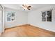 Bedroom featuring hardwood floors, two windows, and neutral paint at 1765 Xenia St, Denver, CO 80220