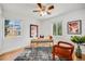 Bright bedroom with hardwood floors, a ceiling fan, and two windows at 1765 Xenia St, Denver, CO 80220