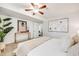 Spacious bedroom with plush carpeting, ceiling fan, large framed art and neutral decor at 1765 Xenia St, Denver, CO 80220
