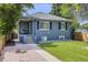 Charming home with a well-maintained lawn and inviting front porch at 1765 Xenia St, Denver, CO 80220
