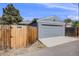 Exterior of property with fenced-in backyard and grey garage with a blue sky at 1765 Xenia St, Denver, CO 80220