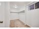 Walk-in closet features carpeted floor, a window, and an adjustable hanging rack at 1765 Xenia St, Denver, CO 80220