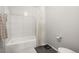 Bathroom featuring white tile, a shower and tub combination, and modern fixtures at 3471 S Ammons St # 12-6, Lakewood, CO 80227
