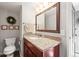 Cozy bathroom featuring a single sink vanity with granite counters and wood cabinets at 3471 S Ammons St # 12-6, Lakewood, CO 80227