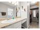Bathroom featuring a walk-in closet and an over-sized mirror at 3471 S Ammons St # 12-6, Lakewood, CO 80227