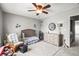 Light-filled Bedroom with ceiling fan, plush carpet, and a peek into the laundry area at 3471 S Ammons St # 12-6, Lakewood, CO 80227