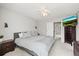 Bedroom with mounted TV, gray walls, carpet, and furniture at 3471 S Ammons St # 12-6, Lakewood, CO 80227
