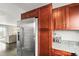 Kitchen view showcasing stainless steel refrigerator and cherry cabinets with contrasting granite countertops at 3471 S Ammons St # 12-6, Lakewood, CO 80227