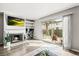 Light-filled living room featuring a fireplace, TV, and sliding glass doors to the backyard at 3471 S Ammons St # 12-6, Lakewood, CO 80227