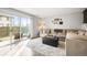 A welcoming living room with a sliding glass door to backyard, lots of natural light, and a cozy seating area at 3471 S Ammons St # 12-6, Lakewood, CO 80227