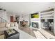 Bright living room boasts a fireplace, TV, desk, and open layout to dining area and kitchen, great for modern living at 3471 S Ammons St # 12-6, Lakewood, CO 80227