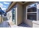 Inviting back porch featuring a tiled floor, exterior access door, and a large window for plenty of sunlight at 2901 Wyandot St # 18, Denver, CO 80211