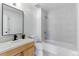 Bright bathroom featuring a modern vanity, tile flooring, and a shower-over-tub with gray tiling at 2901 Wyandot St # 18, Denver, CO 80211