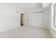 Spacious bedroom featuring white carpet, a closet, and an attached bathroom at 2901 Wyandot St # 18, Denver, CO 80211