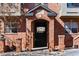 The brick entryway to the building displays 'Highland Court' above the gated entrance at 2901 Wyandot St # 18, Denver, CO 80211