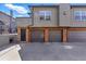 View of the garages with an entryway on a sunny day at 2901 Wyandot St # 18, Denver, CO 80211