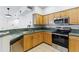 Kitchen features stainless appliances and wooden cabinets with dark countertops at 2901 Wyandot St # 18, Denver, CO 80211