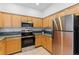 Well-lit kitchen features stainless steel appliances, stylish cabinets, and dark countertops at 2901 Wyandot St # 18, Denver, CO 80211