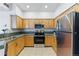 Well-lit kitchen features stainless steel appliances, stylish cabinets, and dark countertops at 2901 Wyandot St # 18, Denver, CO 80211