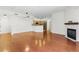 Sun-drenched living area featuring hardwood floors, neutral walls, recessed lighting, and a cozy fireplace leading into a modern kitchen at 2901 Wyandot St # 18, Denver, CO 80211