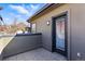 Private patio with gray pavers, stucco walls, and a glass door that lets in light at 2901 Wyandot St # 18, Denver, CO 80211