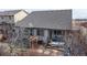 An aerial view of the back exterior shows patio with pergola and fenced yard at 5280 Longs Peak St, Brighton, CO 80601