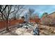 Serene backyard with a stone patio seating area and well-maintained landscaping at 5280 Longs Peak St, Brighton, CO 80601
