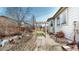Backyard featuring a pergola, decorative stones, and a well-manicured lawn at 5280 Longs Peak St, Brighton, CO 80601