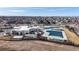 Stunning aerial view of the neighborhood pool and clubhouse with mountain views in the distance at 5280 Longs Peak St, Brighton, CO 80601