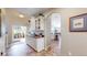 Inviting entryway with built-in storage and glass-paneled door leading to a bright sunroom, enhancing the home's charm at 5280 Longs Peak St, Brighton, CO 80601