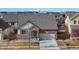 Charming single-Gathering home featuring a well-maintained lawn, brick facade, and attached two-car garage at 5280 Longs Peak St, Brighton, CO 80601