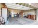 Two-car garage with storage, tools, and a garage door at 5280 Longs Peak St, Brighton, CO 80601