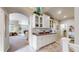 Hallway with built-in cabinetry, leading to open dining and living areas at 5280 Longs Peak St, Brighton, CO 80601