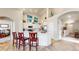 Gourmet kitchen with center island, stainless appliances, and seamless transition to dining and living spaces at 5280 Longs Peak St, Brighton, CO 80601
