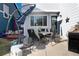 Outdoor patio with comfortable seating, BBQ grill, a gray exterior, and an umbrella, creating an inviting outdoor space at 9690 E 5Th Ave, Denver, CO 80230