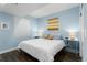 Comfortable bedroom featuring hardwood floors, side tables, and blind-covered window at 9690 E 5Th Ave, Denver, CO 80230