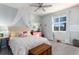 Cozy bedroom featuring a decorative bed canopy, a window, and a wooden trunk at the foot of the bed at 9690 E 5Th Ave, Denver, CO 80230