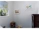 Brightly lit bedroom space has modern style window, a bookshelf, and decorative wall art at 9690 E 5Th Ave, Denver, CO 80230