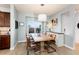 Bright dining room features wood floors, a large window, modern light fixture, and stylish table and chairs at 9690 E 5Th Ave, Denver, CO 80230