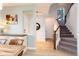 Welcoming entryway features a staircase, wood floors, shiplap accent wall, and convenient access to the main living areas at 9690 E 5Th Ave, Denver, CO 80230