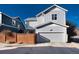 Charming two-story home with a gray siding, a well-maintained yard, and a large two-car garage, perfect for Gathering living at 9690 E 5Th Ave, Denver, CO 80230