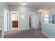 Upstairs hallway showcasing access to a bathroom, laundry, and bedrooms; all spaces feature neutral walls and carpet at 9690 E 5Th Ave, Denver, CO 80230