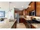 Well-appointed kitchen with granite countertops, stainless steel appliances, and a breakfast bar, perfect for casual dining at 9690 E 5Th Ave, Denver, CO 80230