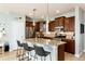 Modern kitchen featuring granite countertops, stainless steel appliances, a breakfast bar, and pendant lighting at 9690 E 5Th Ave, Denver, CO 80230