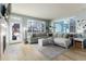 Spacious living room boasting natural light, a comfortable gray sectional sofa, and access to the outdoor patio at 9690 E 5Th Ave, Denver, CO 80230
